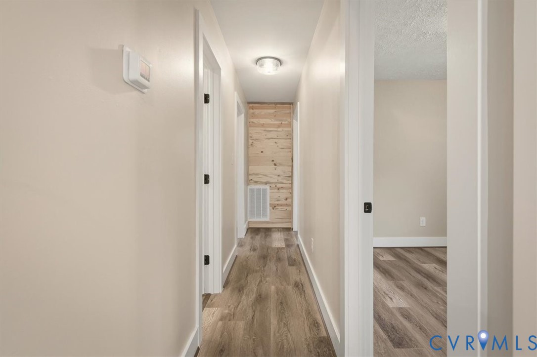 2495 Jackson Shop Road Goochland, VA 23063 - Photo 19 of 38 a view of a hallway with wooden floor and staircase