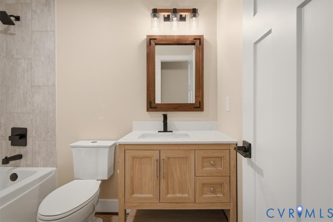 2495 Jackson Shop Road Goochland, VA 23063 - Photo 22 of 38 a bathroom with a granite countertop toilet sink and mirror
