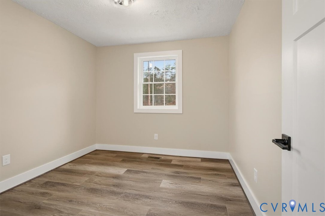 2495 Jackson Shop Road Goochland, VA 23063 - Photo 23 of 38 wooden floor in an empty room with a window