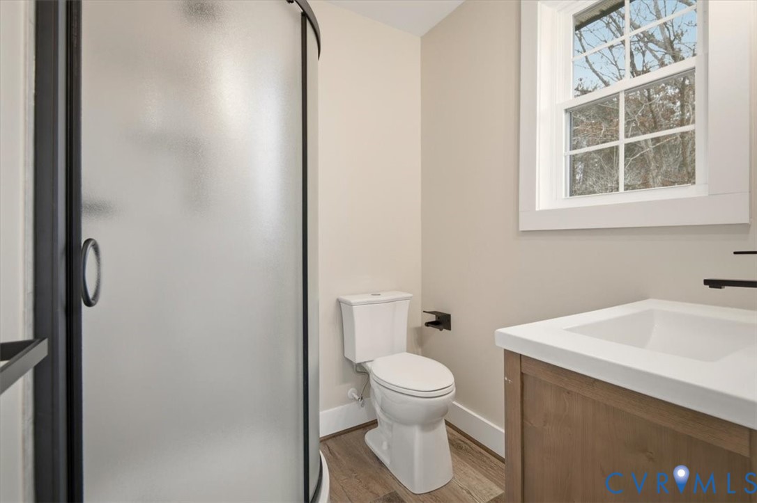 2495 Jackson Shop Road Goochland, VA 23063 - Photo 29 of 38 a white toilet sitting next to a bathroom sink