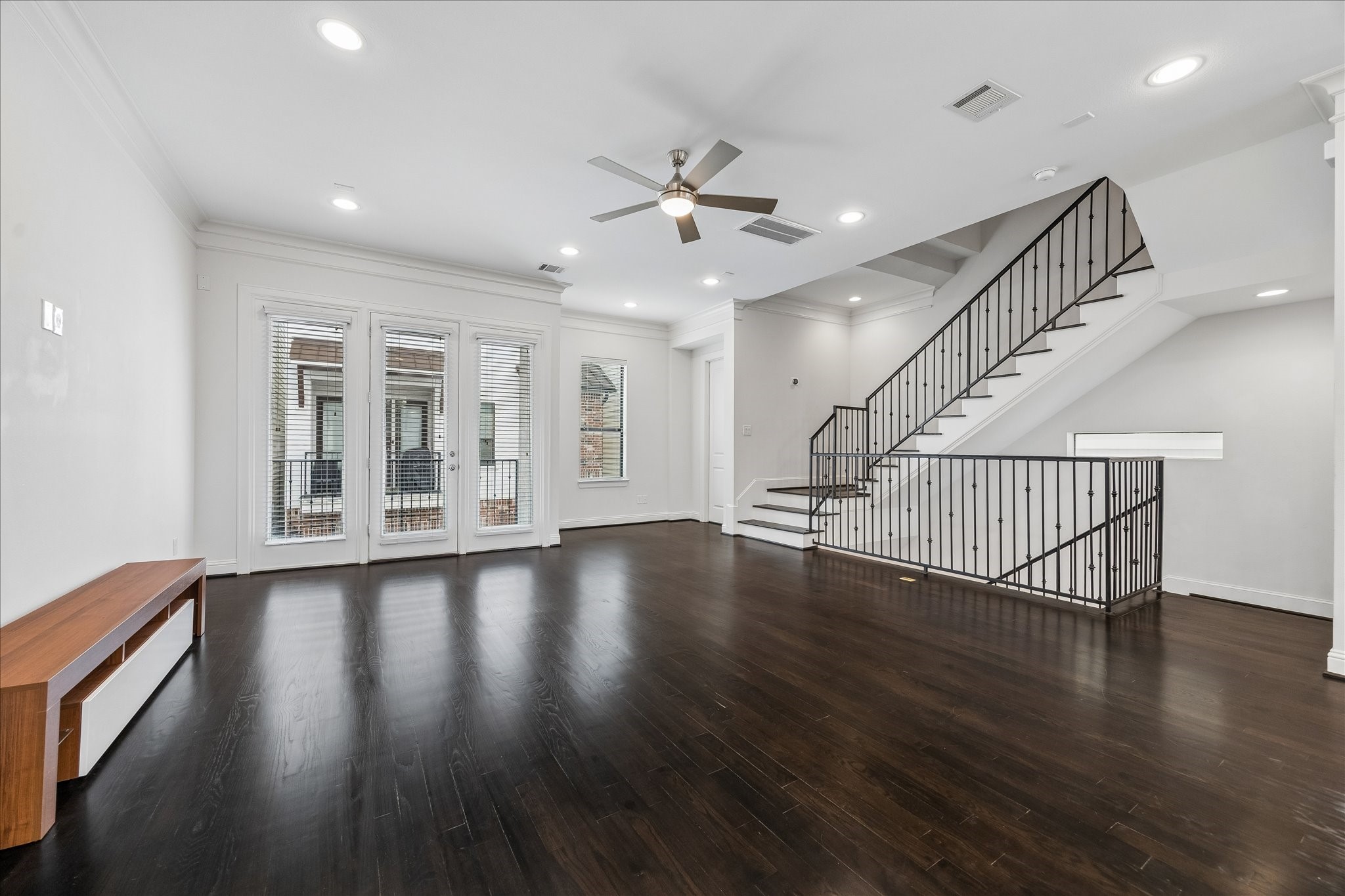 734 West 20th Street, Unit A Houston, TX 77008 - Photo 10 of 23 Another perspective highlights the expansive layout & natural light, w/ iron railing detail adding architectural interest & a seamless connection across the living space.