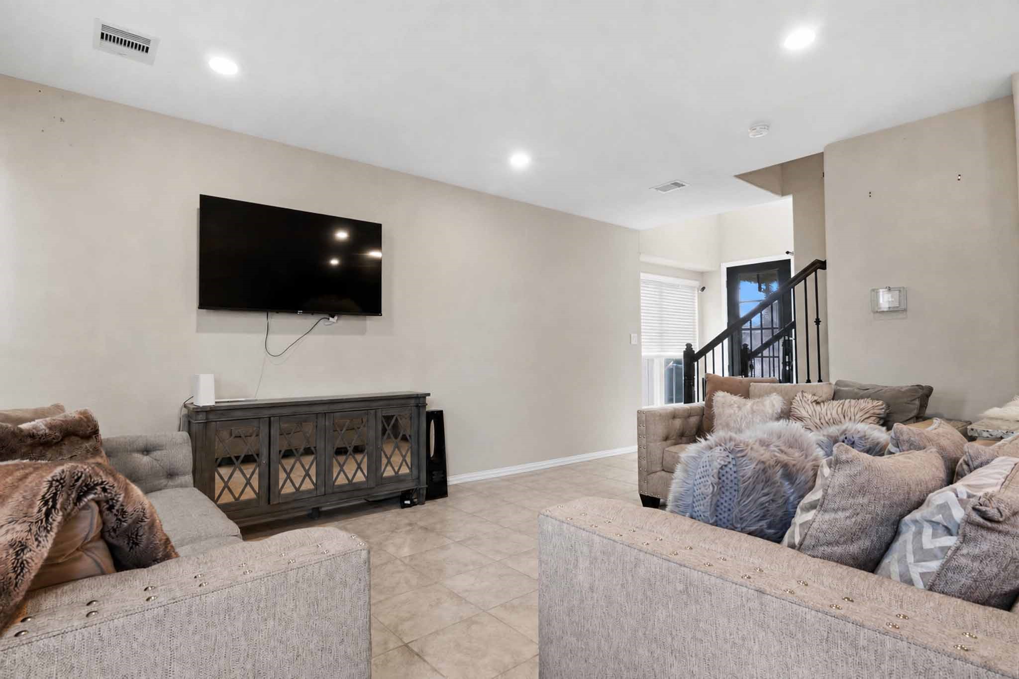 1815 Ryon Falls Drive Richmond, TX 77469 - Photo 7 of 24 a living room with furniture a flat screen tv and a fireplace