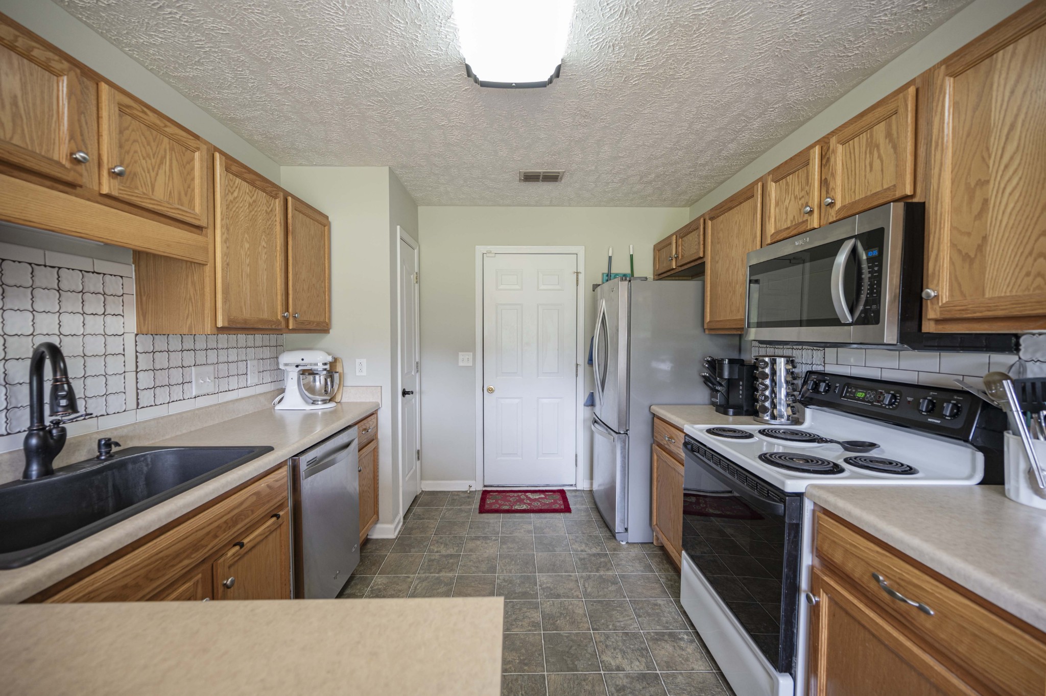 1237 Macduff Drive Murfreesboro, TN 37128 - Photo 6 of 20 a kitchen that has a sink and a stove top oven