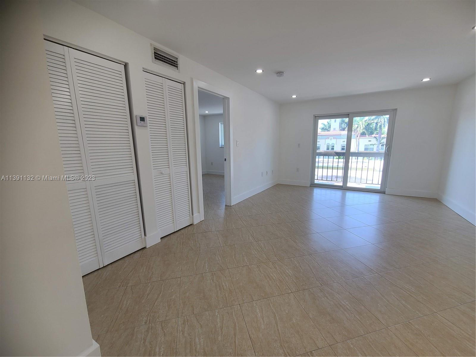 1612 Jefferson Avenue, Unit 403 Miami Beach, FL 33139 - Photo 17 of 55 an empty room with wooden floor and windows