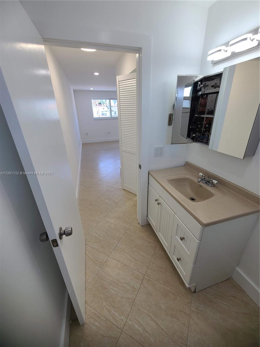 1612 Jefferson Avenue, Unit 403 Miami Beach, FL 33139 - Photo 39 of 55 a bathroom with a sink a toilet a mirror and vanity