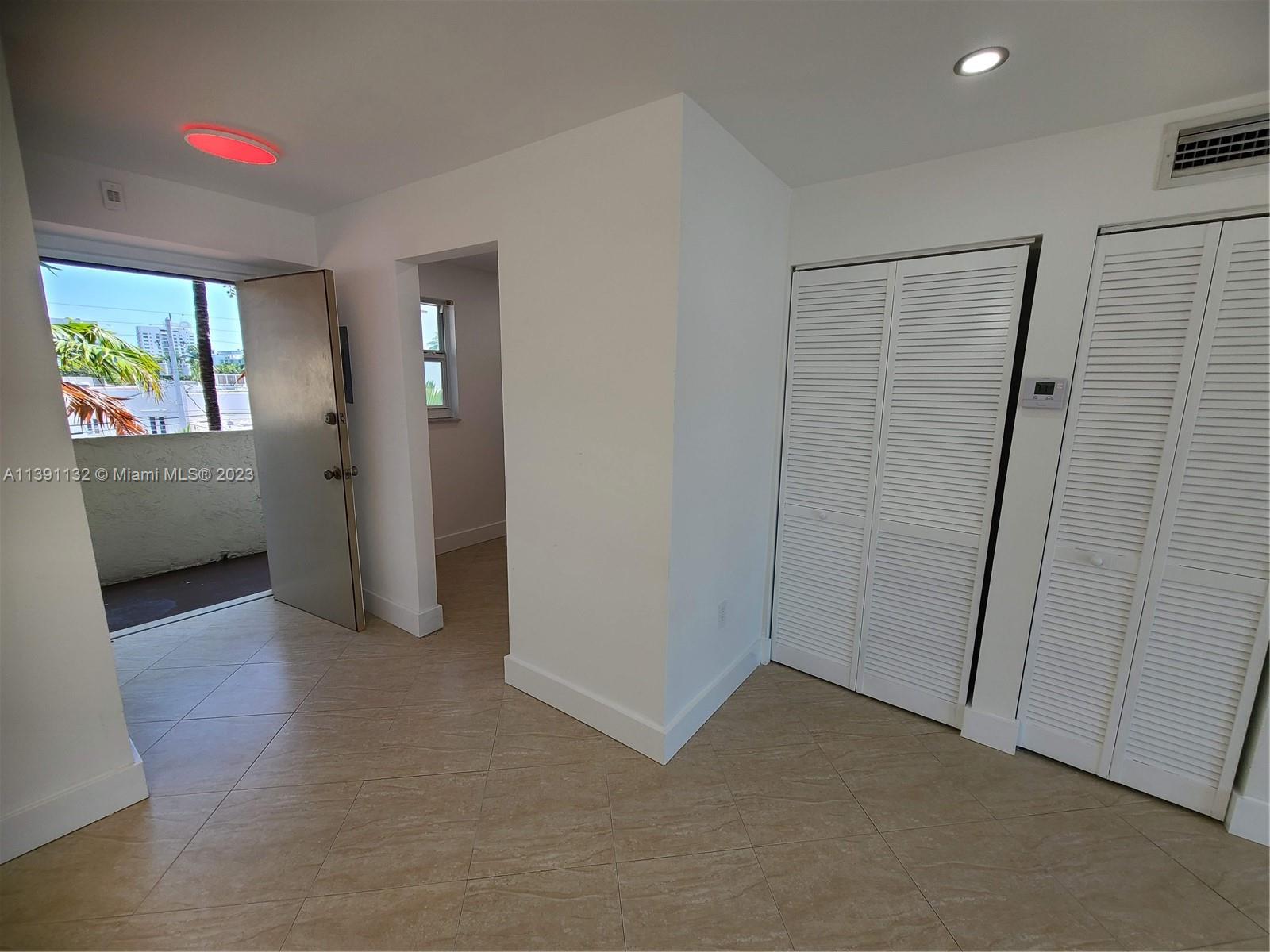 1612 Jefferson Avenue, Unit 403 Miami Beach, FL 33139 - Photo 42 of 55 an empty room with windows cabinet and mirror