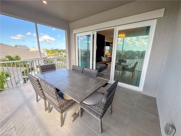 a view of a dining table and chairs in porch
