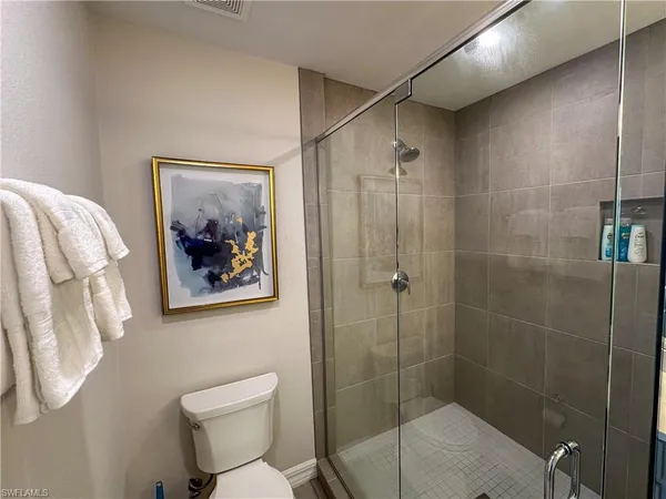 a hallway with sink and wooden floor