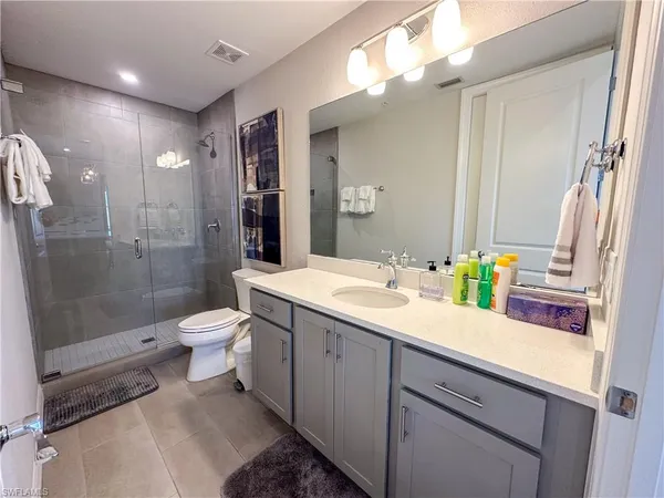 a bathroom with a sink a toilet a mirror and vanity
