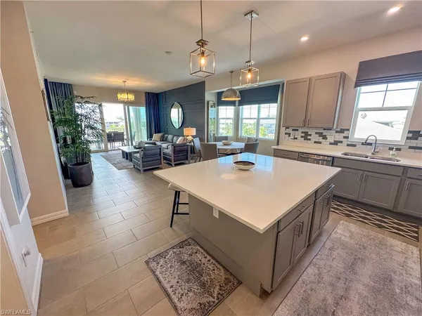 a kitchen with sink stove and living room