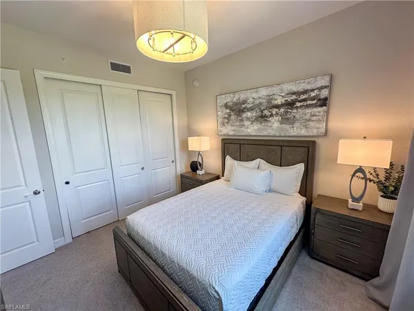 a bedroom with a bed and a dresser