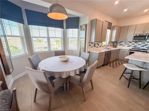 a view of a dining room with furniture and a chandelier