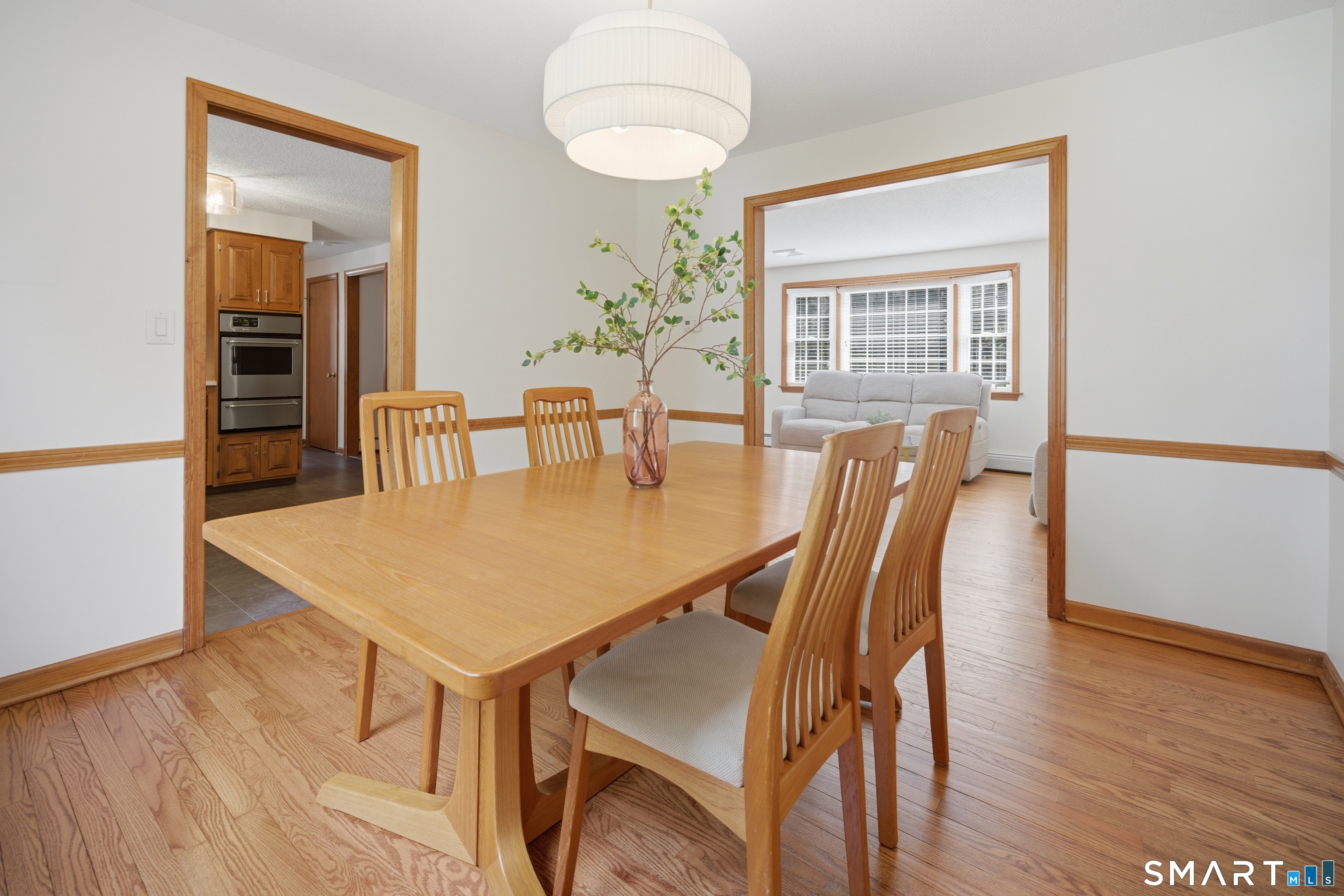 211 Valley View Road Manchester, CT 06040 - Photo 17 of 39 a view of a dining room with furniture and wooden floor
