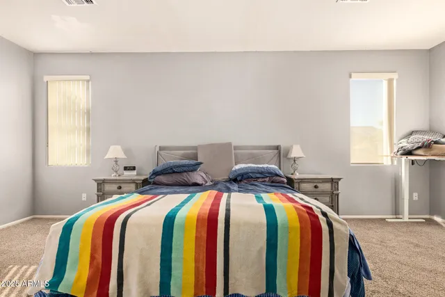 a bed sitting in a bedroom next to a window