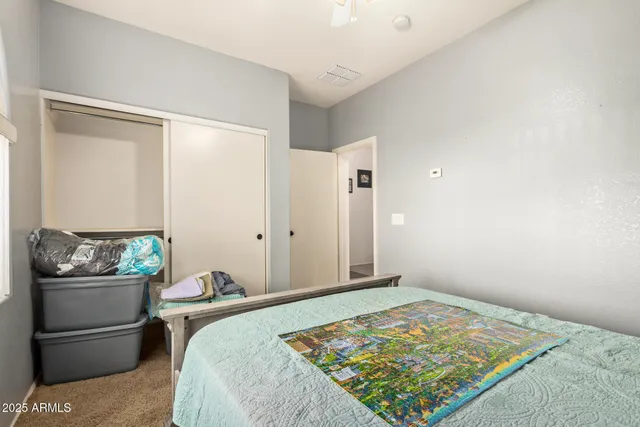 a bedroom with a bed and a dresser