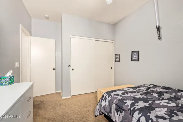 a bedroom with a bed and a dresser