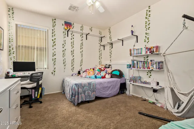 a bedroom with a workspace