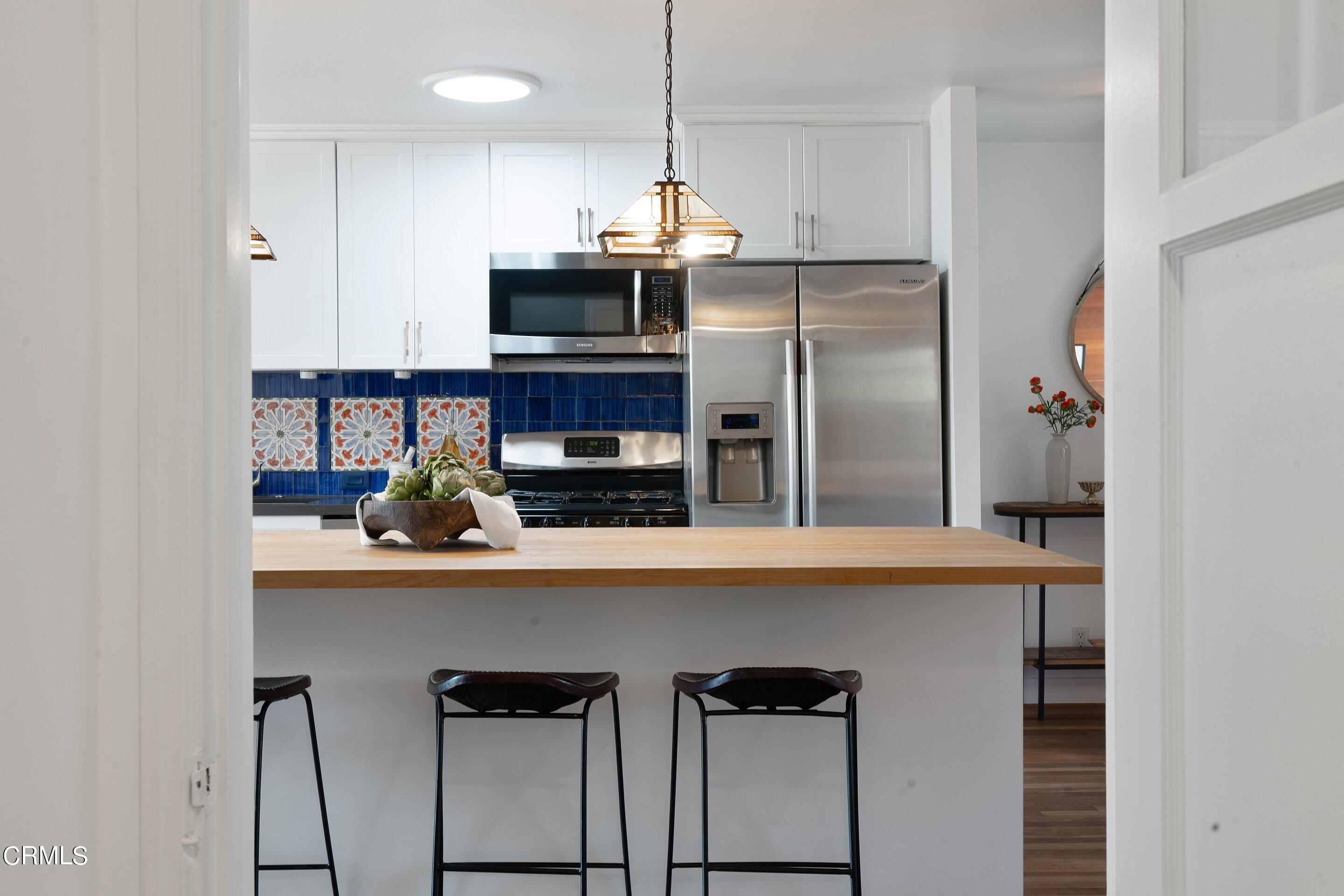 1532 Atchison Street Pasadena, CA 91104 - Photo 12 of 45 a kitchen with stainless steel appliances granite countertop a sink a refrigerator and a stove