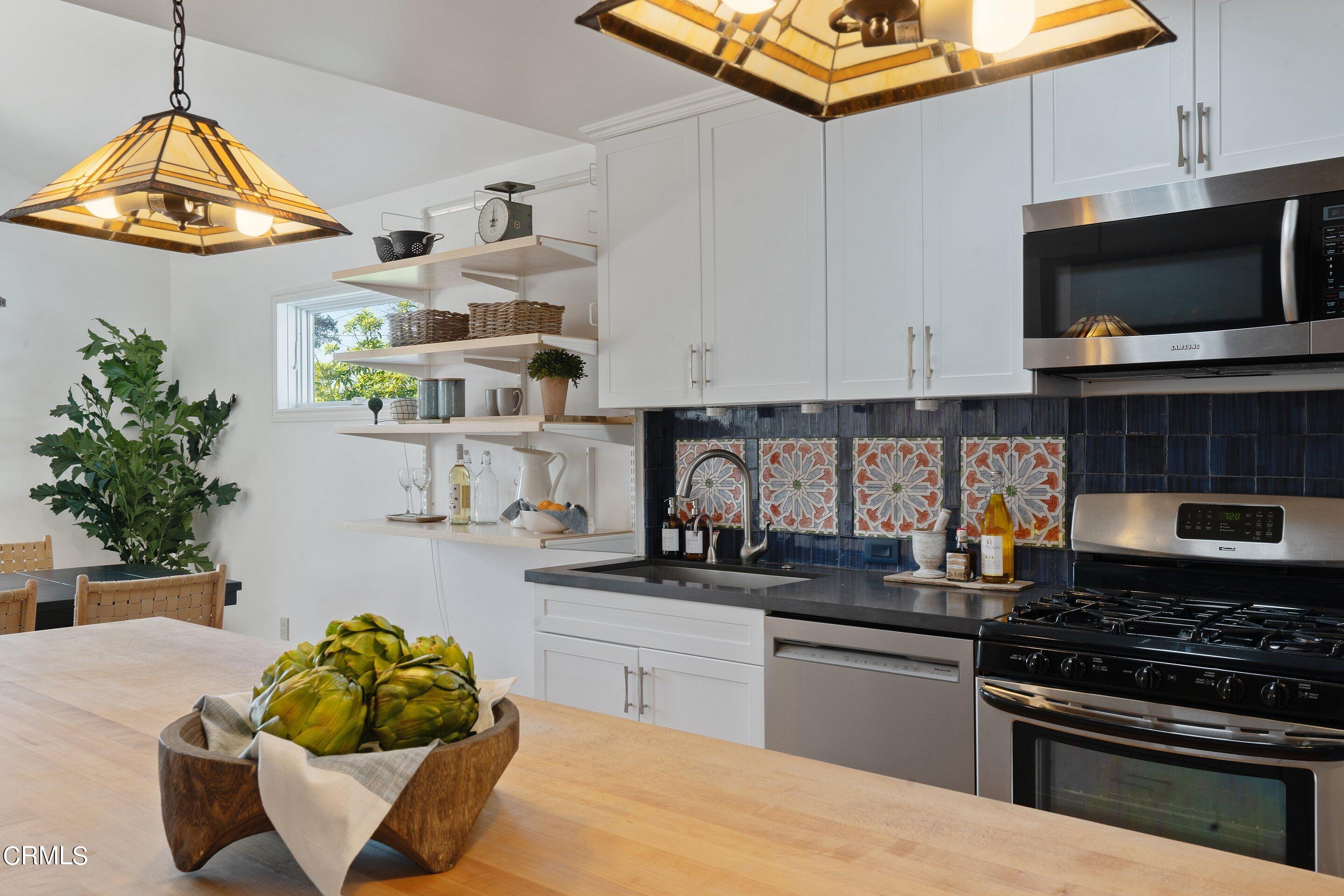 1532 Atchison Street Pasadena, CA 91104 - Photo 13 of 45 a kitchen with stainless steel appliances kitchen island granite countertop a sink and a stove
