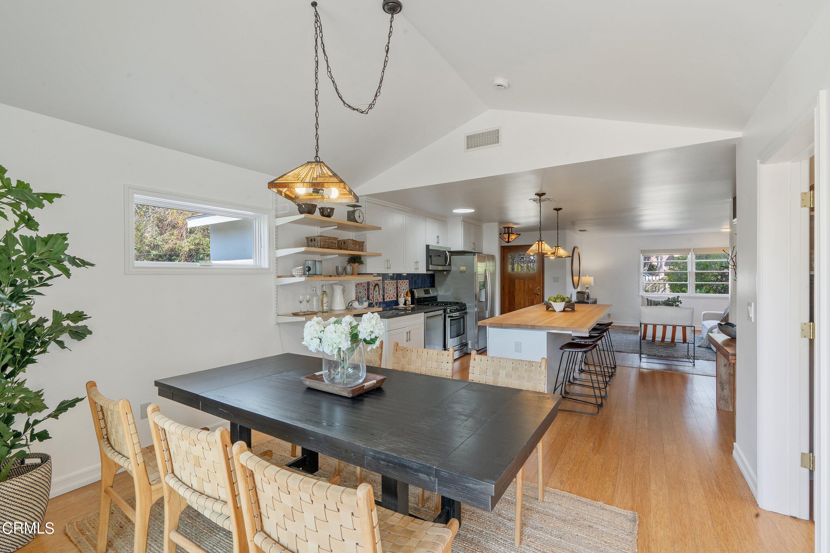 1532 Atchison Street Pasadena, CA 91104 - Photo 18 of 45 a dining room with furniture a chandelier and wooden floor