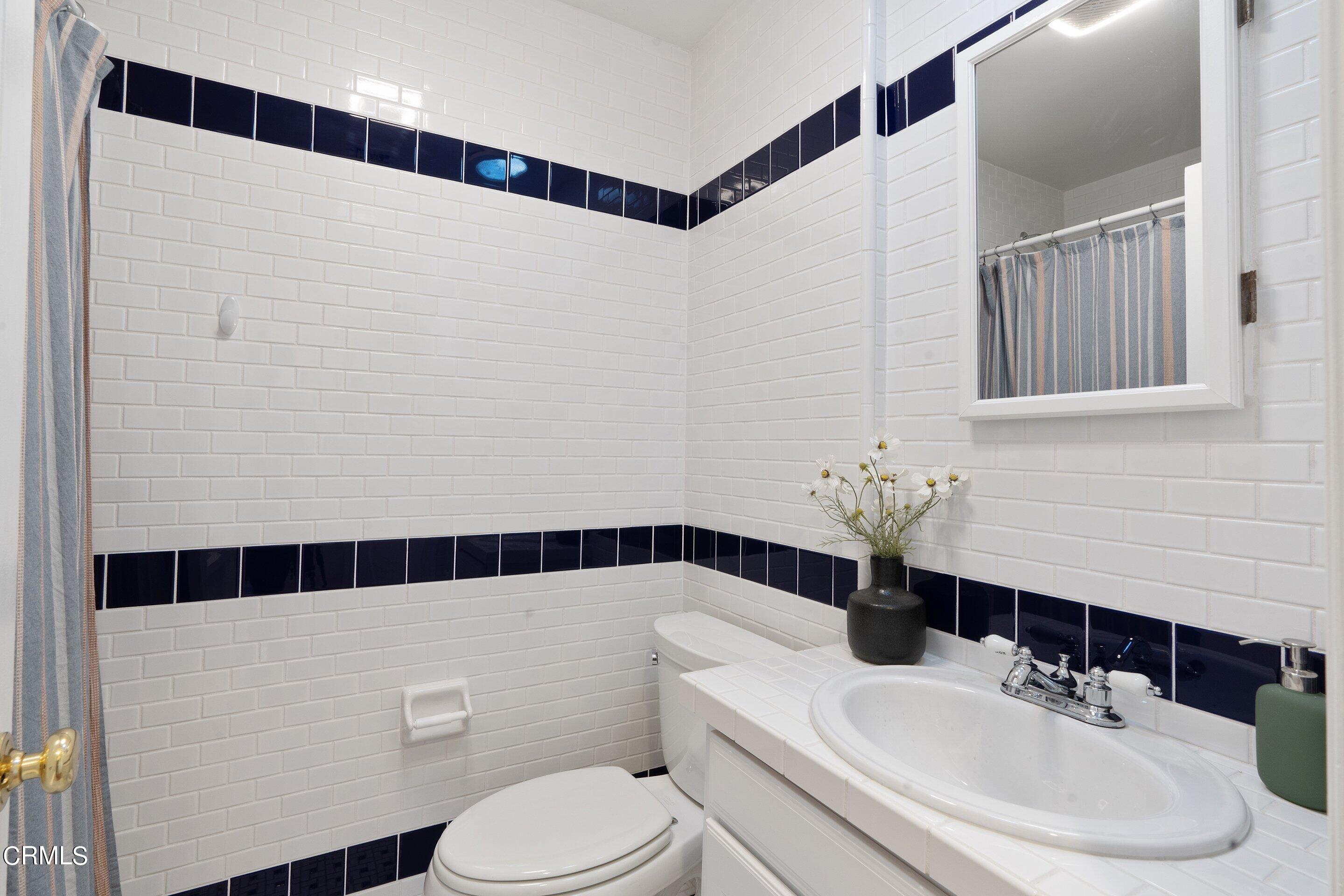 1532 Atchison Street Pasadena, CA 91104 - Photo 28 of 45 a bathroom with a sink a toilet and shower