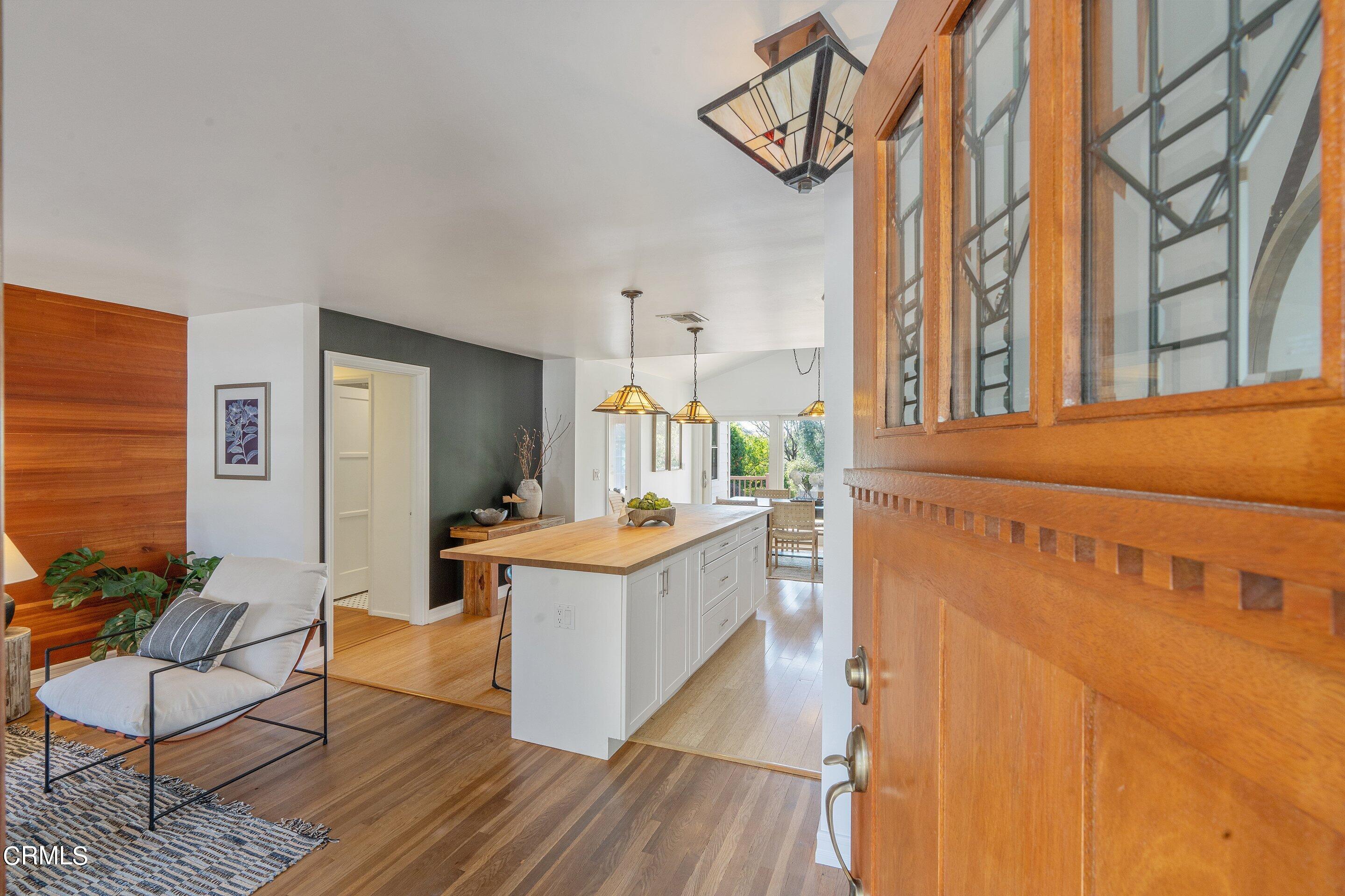 1532 Atchison Street Pasadena, CA 91104 - Photo 5 of 45 a living room with furniture a flat screen tv and kitchen view