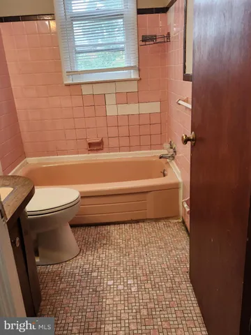 a bathroom with a toilet and a bathtub