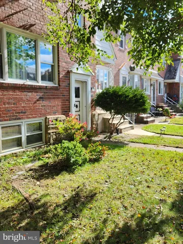 a view of a house with a yard and plants