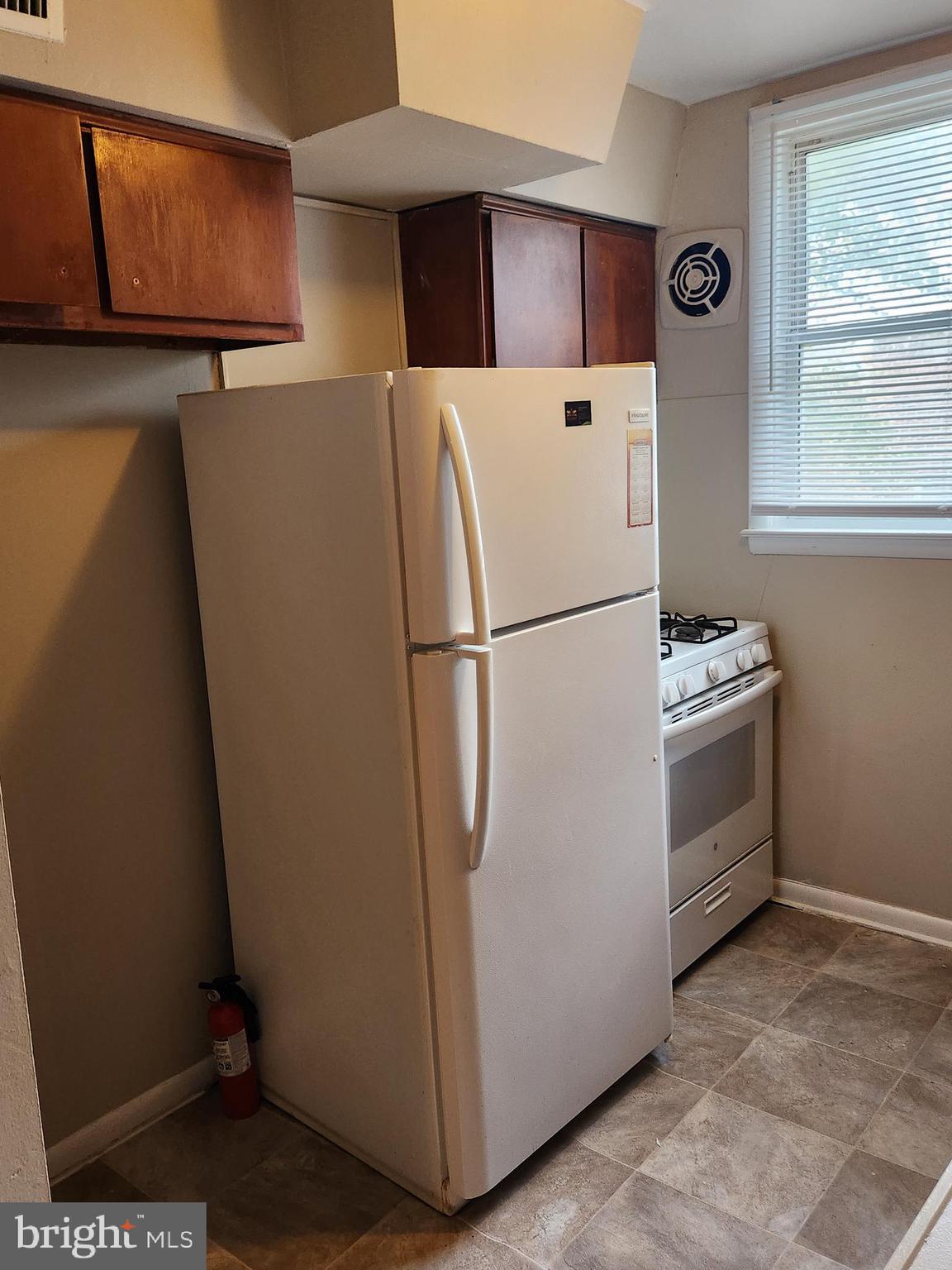 6651 Claridge Street Philadelphia, PA 19111 - Photo 9 of 26 a white refrigerator freezer and a stove sitting inside of a kitchen