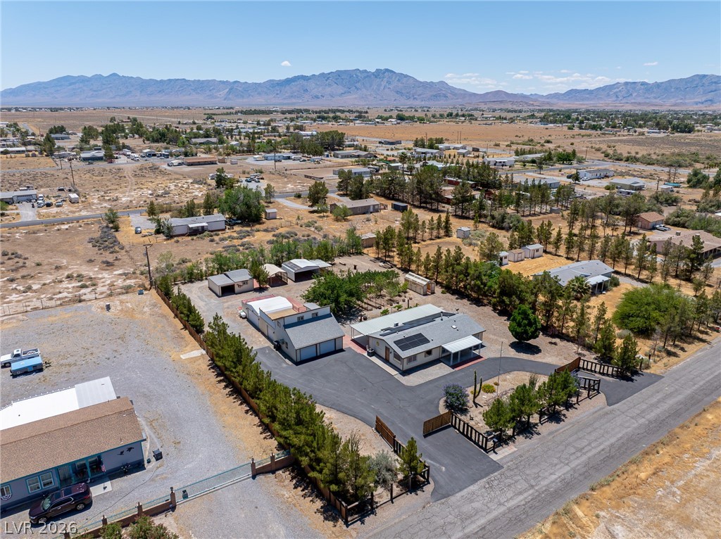1831 West Horn Road Pahrump, NV 89048 - Photo 50 of 59 An aerial panorama reveals a private desert oasis nestled against a dramatic mountain backdrop.