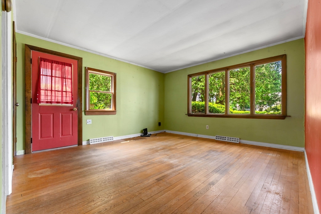 71 Union Street Hamilton, MA 01982 - Photo 3 of 21 a view of an empty room with a window and wooden floor