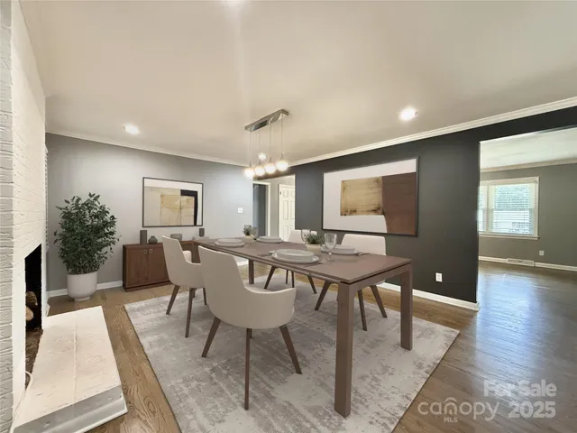 a living room with furniture a wooden floor and next to a window