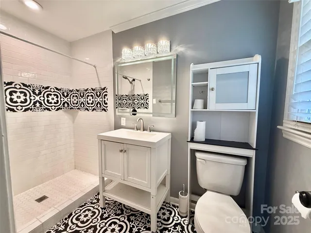 a bathroom with a sink toilet and shower