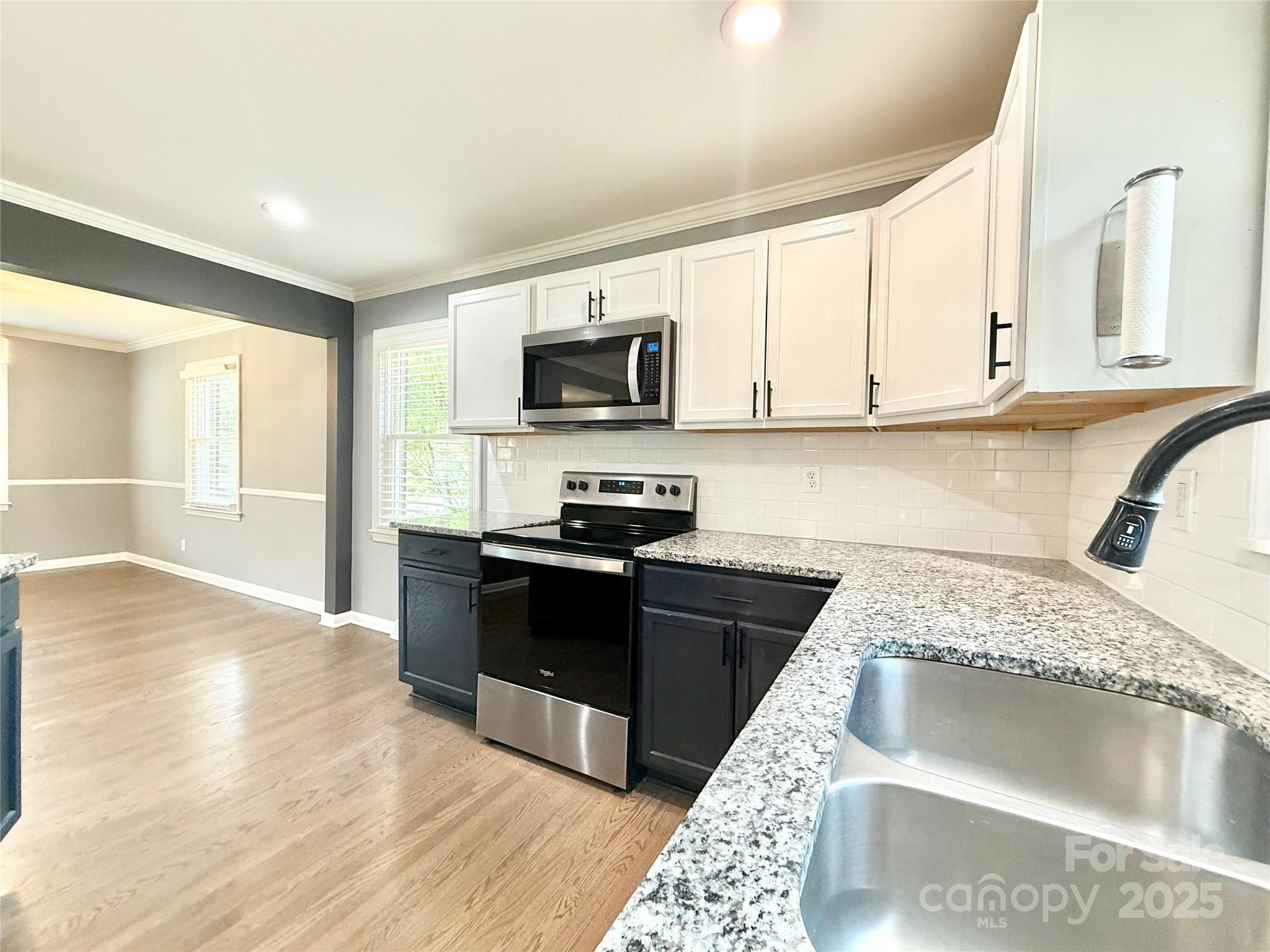 622 University Drive Rock Hill, SC 29730 - Photo 9 of 24 a kitchen with granite countertop a sink and a stove top oven