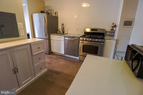 a kitchen with cabinets and white appliances
