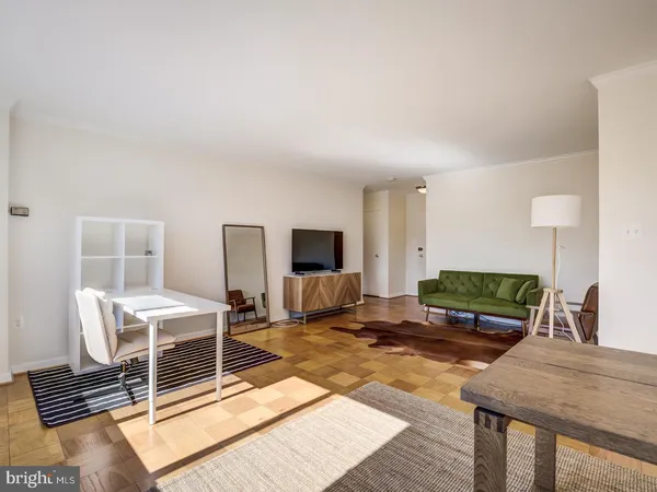 a living room with a balcony furniture and a flat screen tv