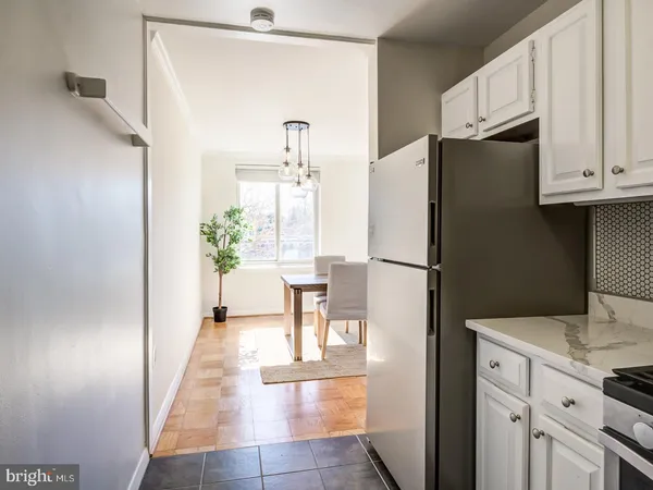 a kitchen with stainless steel appliances a refrigerator and a stove