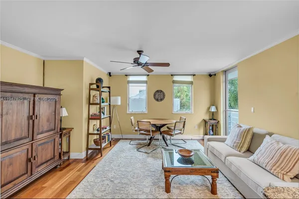 a living room with furniture a wooden floor and a table