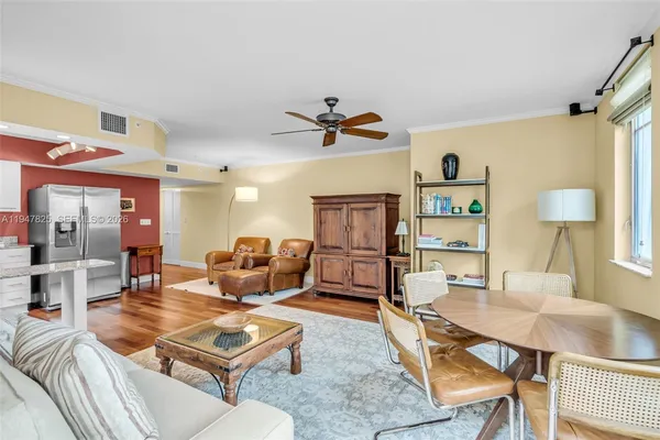 a living room with furniture a table and a chandelier