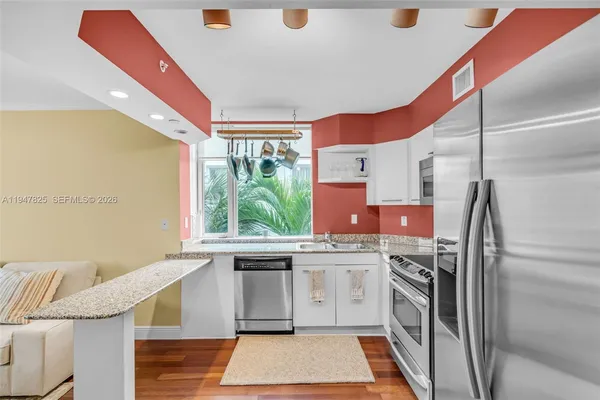 a kitchen with a sink appliances and cabinets