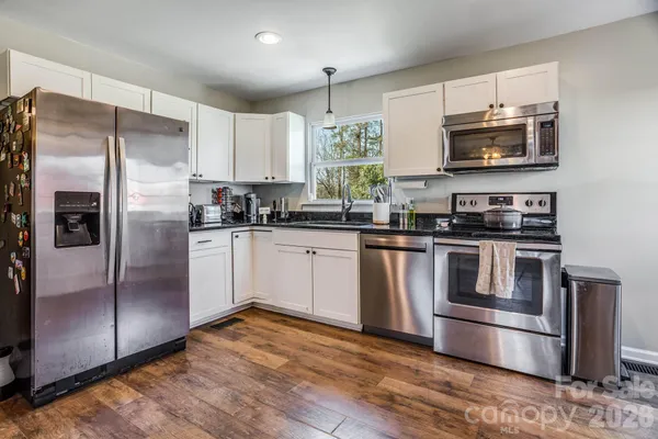 a kitchen with a refrigerator sink and microwave