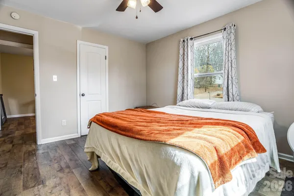 a bedroom with bed and a potted plant