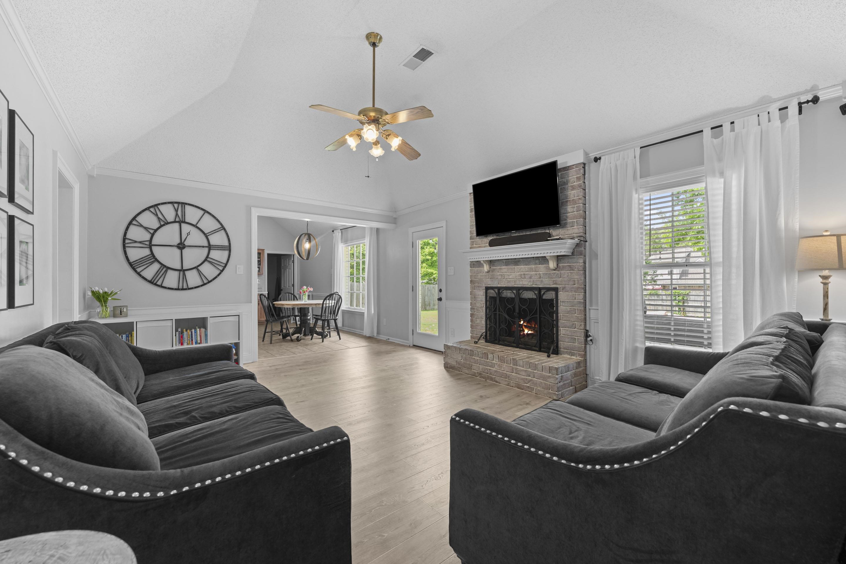 364 Rose Trellis Road Collierville, TN 38017 - Photo 12 of 28 a living room with furniture a flat screen tv and a fireplace