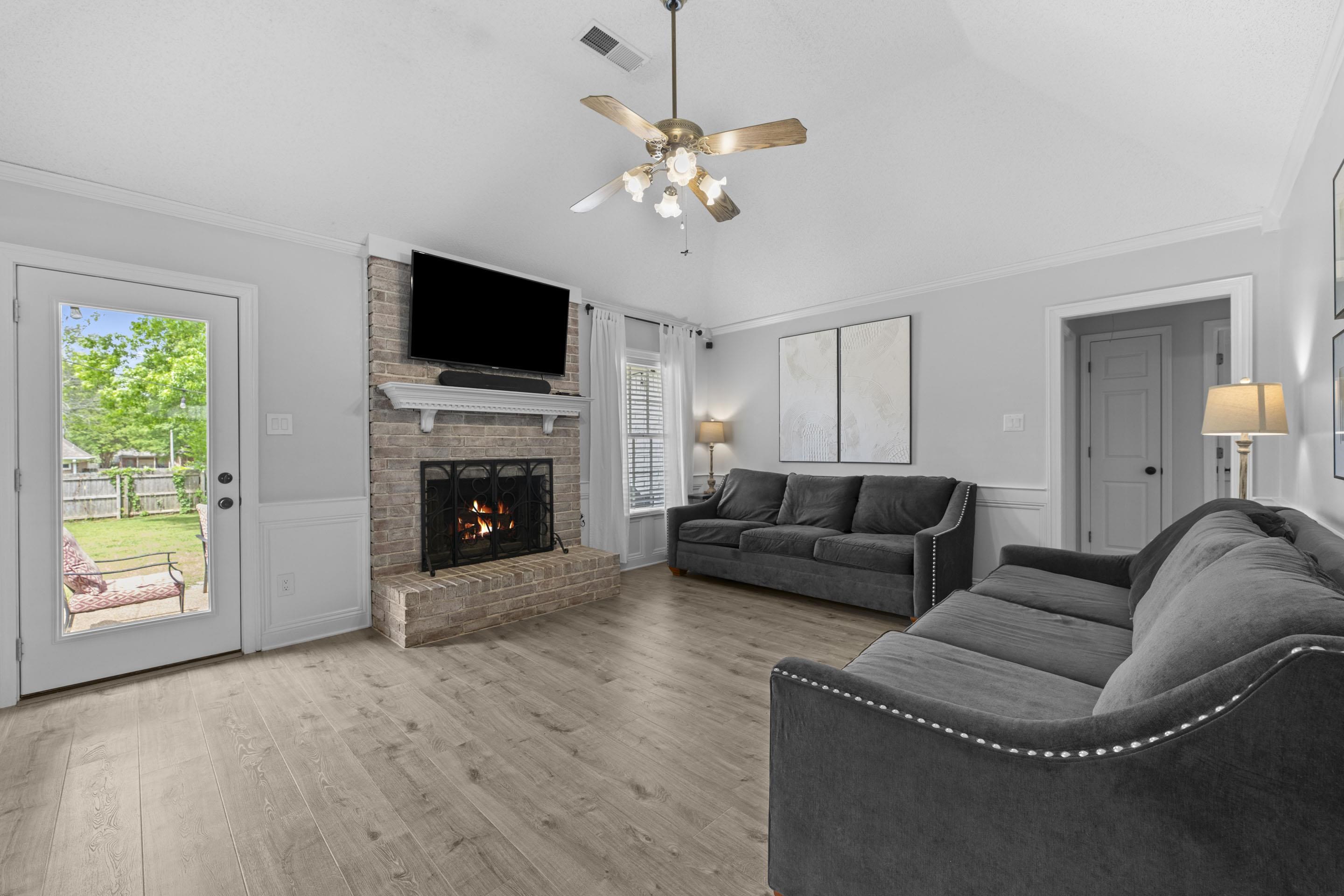 364 Rose Trellis Road Collierville, TN 38017 - Photo 13 of 28 a living room with furniture a flat screen tv and a fireplace
