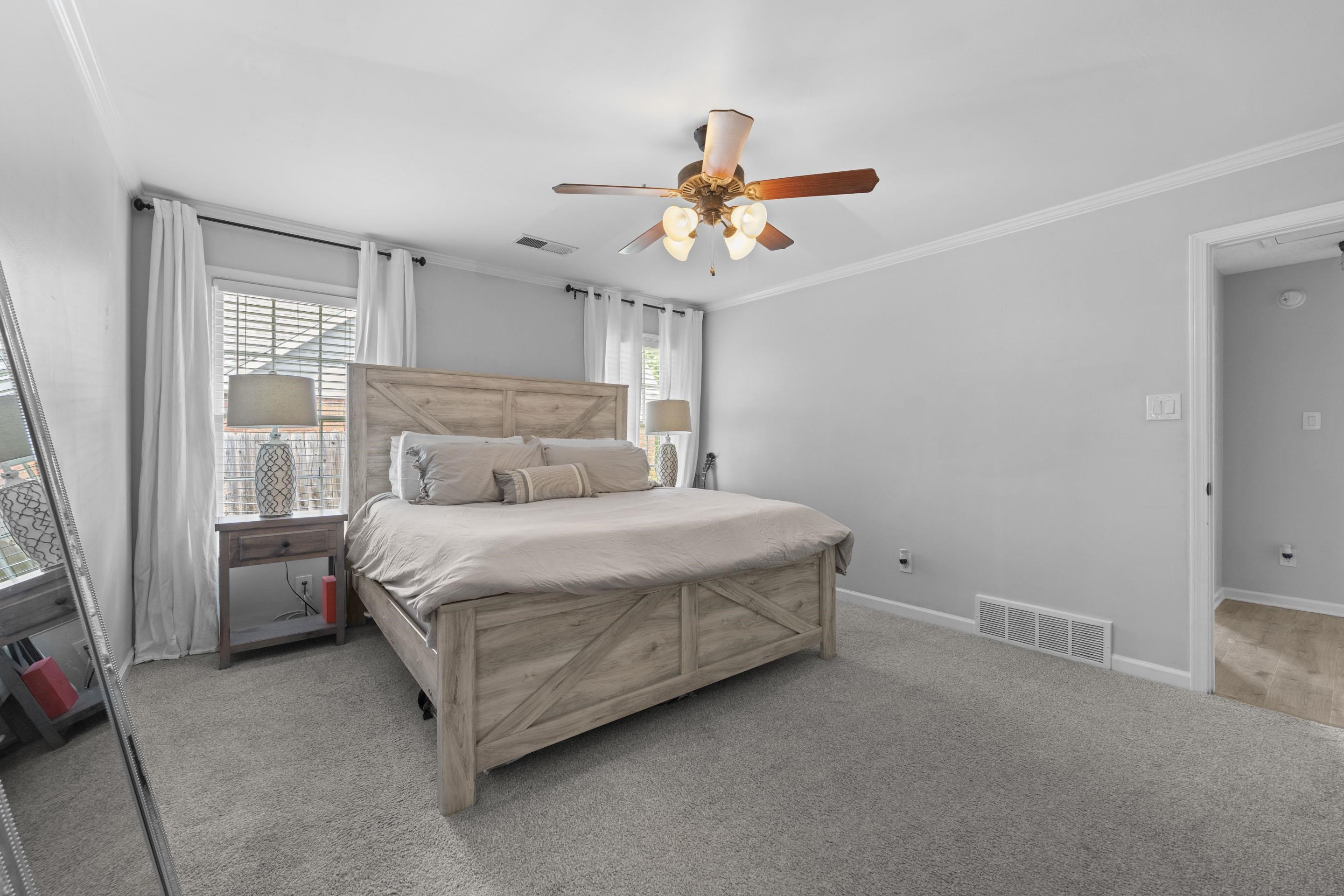 364 Rose Trellis Road Collierville, TN 38017 - Photo 17 of 28 a bedroom with a bed and a chandelier