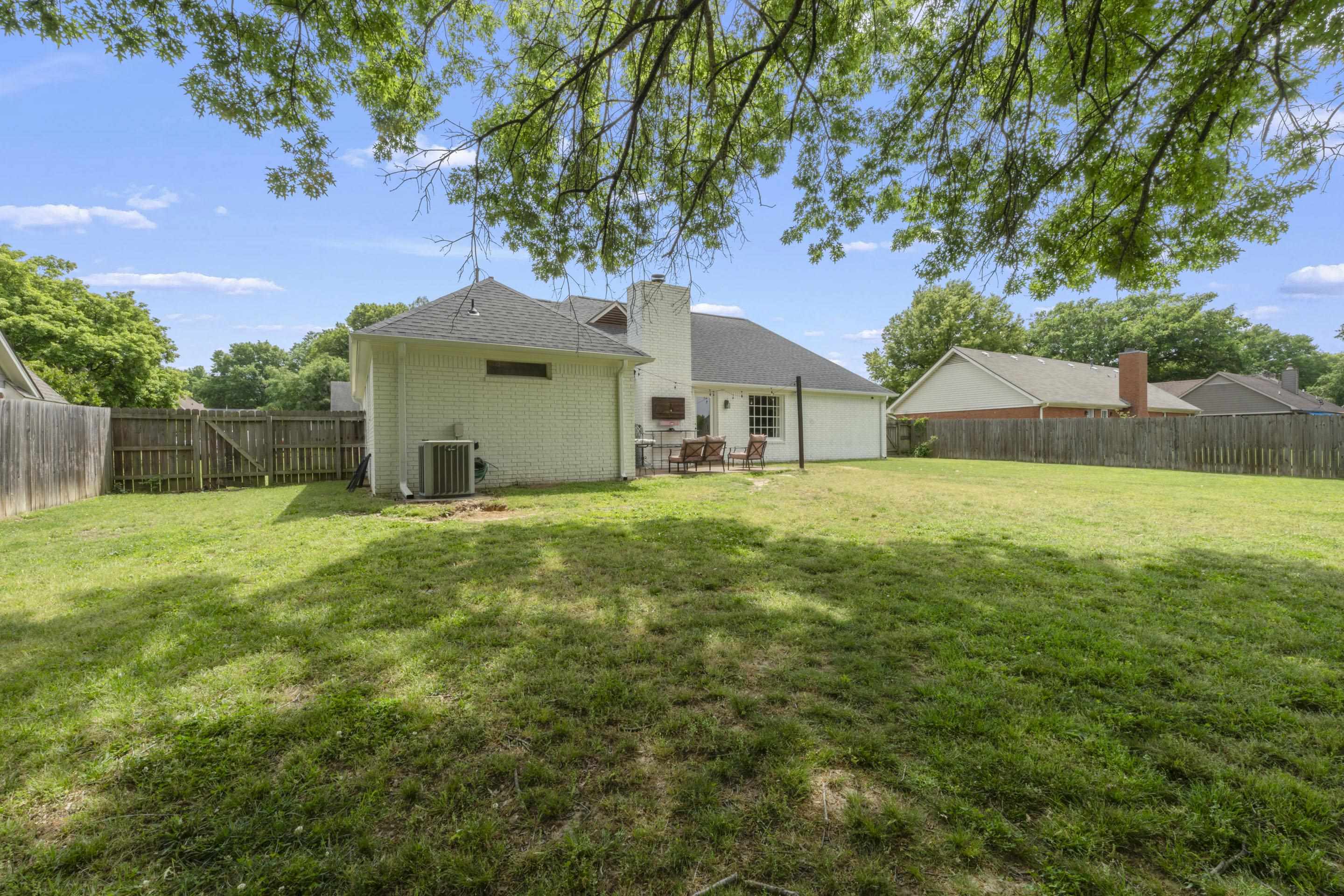 364 Rose Trellis Road Collierville, TN 38017 - Photo 25 of 28 a house that is sitting in the grass with large trees