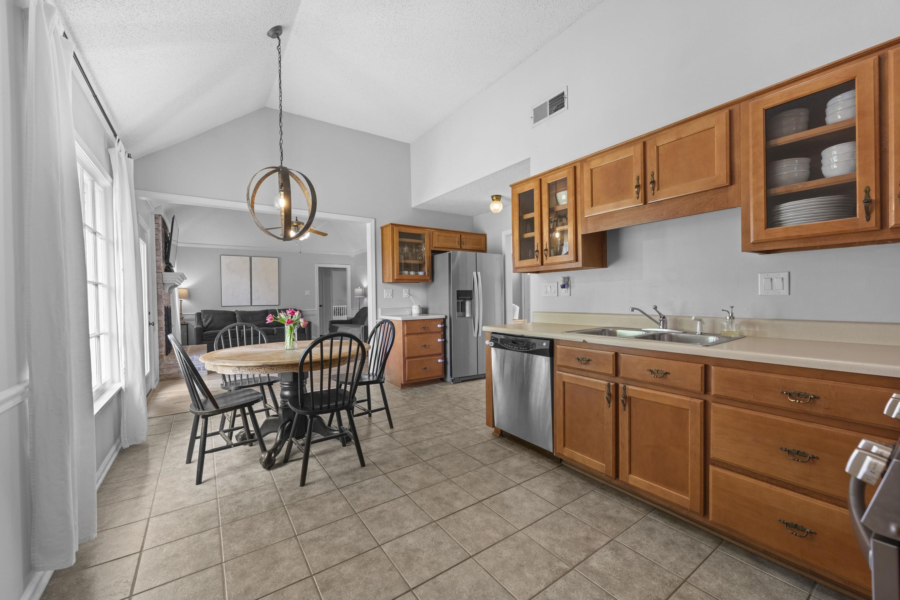364 Rose Trellis Road Collierville, TN 38017 - Photo 8 of 28 a dining hall with stainless steel appliances granite countertop a stove a sink a dining table and chairs with wooden floor