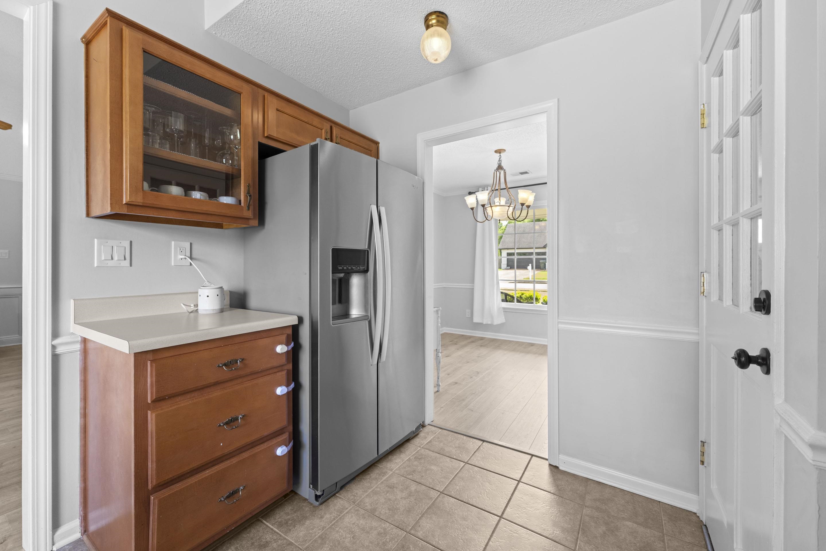 364 Rose Trellis Road Collierville, TN 38017 - Photo 10 of 28 a kitchen with a refrigerator and cabinets