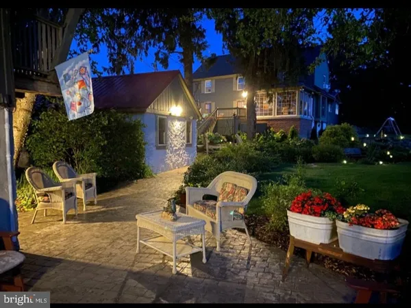 a front view of a house with a garden and plants