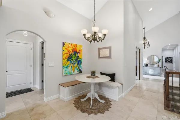 a living room with furniture and painting on the wall